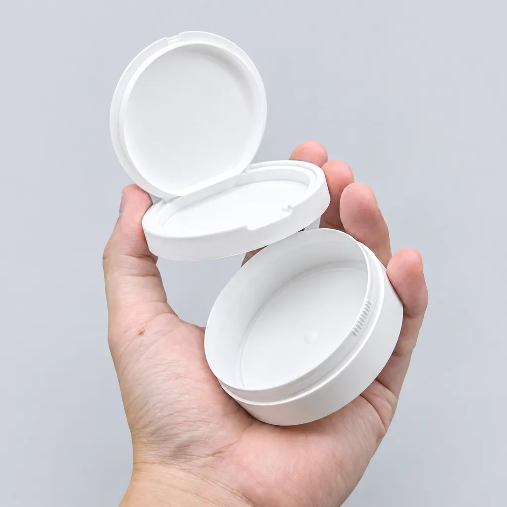 Two white flip-top snus cans with hinged lids open, ready for private-label branding